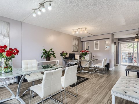 a dining room with a glass table and chairs