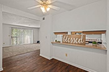 an empty living room with a sign that says blessed