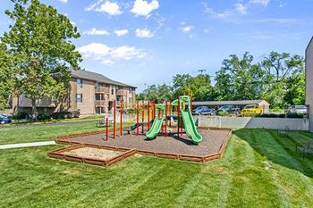 a childrens playground is in the middle of a grass
