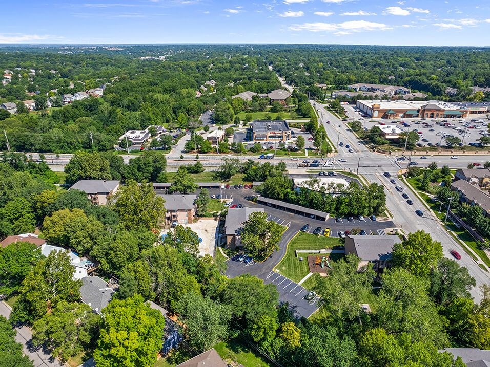 an aerial view of a city with cars and trees