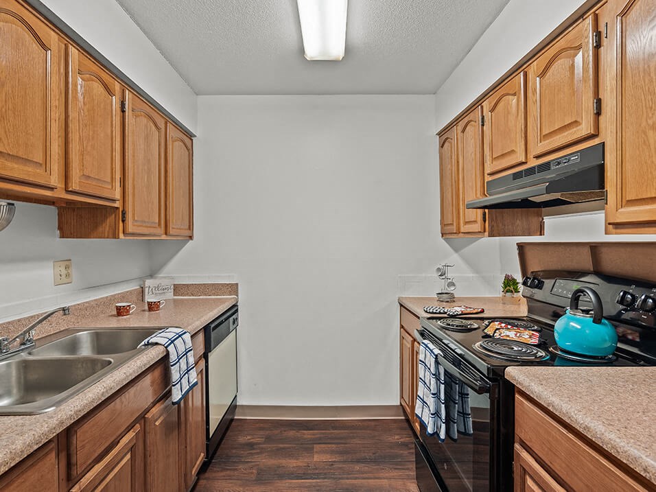 a kitchen with wooden cabinets and a stove top oven