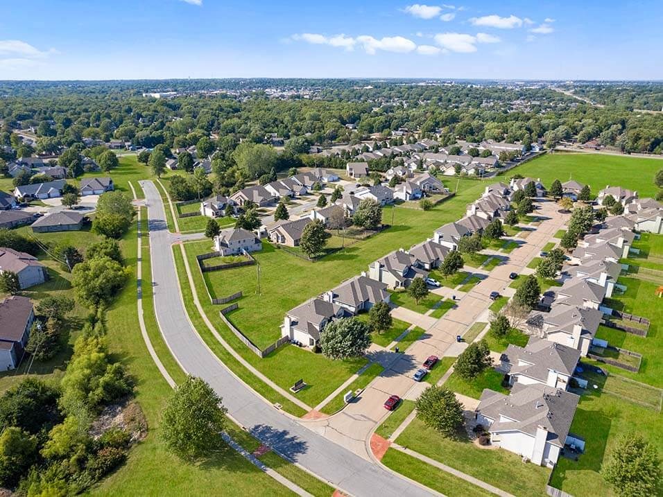 an aerial view of a neighborhood with houses and lawns