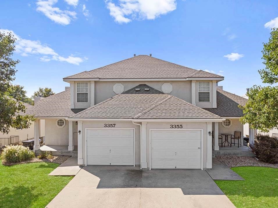 a house with two garage doors on a driveway