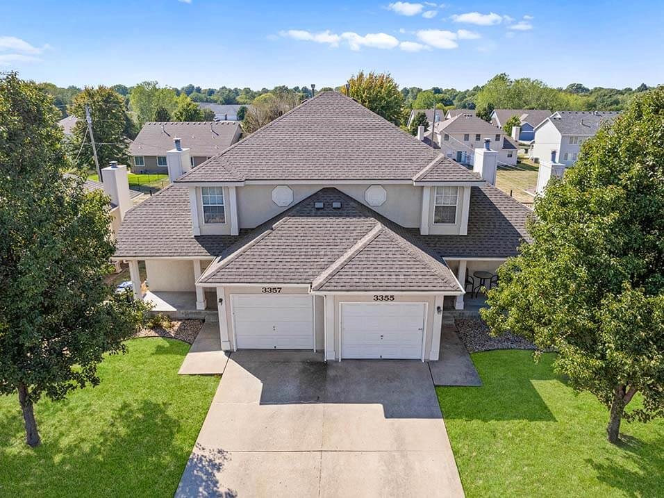 a house with a garage and a yard with trees