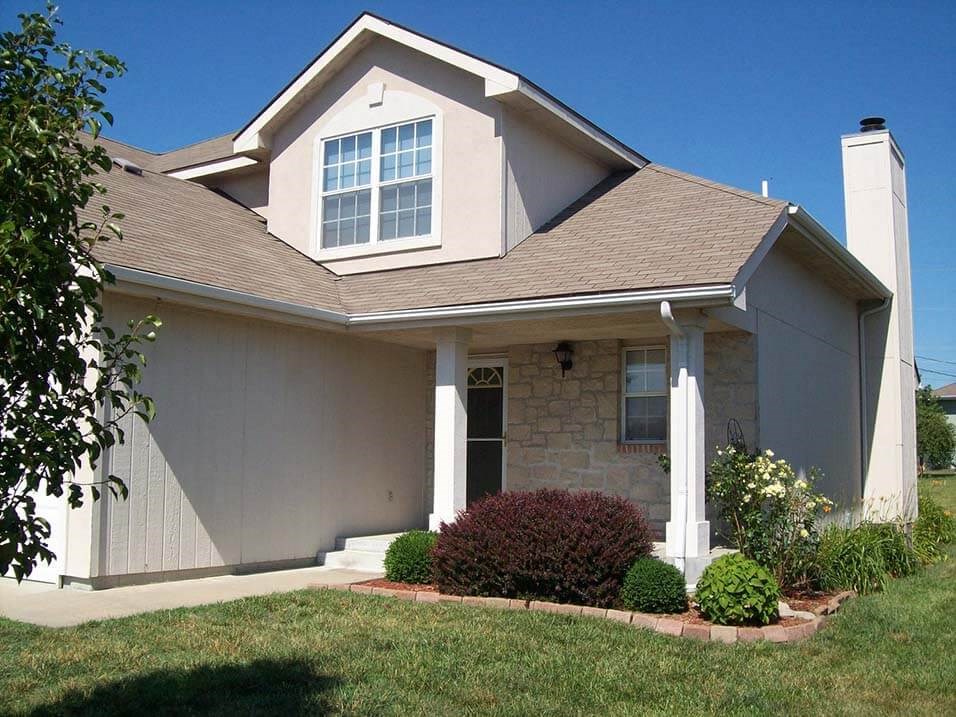 a white house with a lawn in front of it