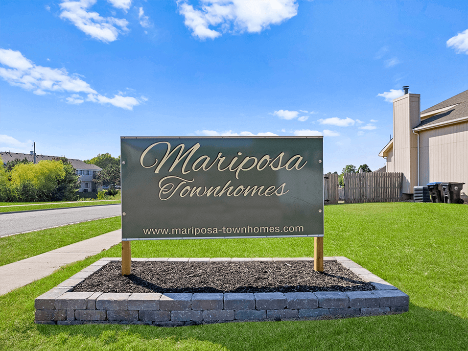 a sign for mariposa vacations in front of a house