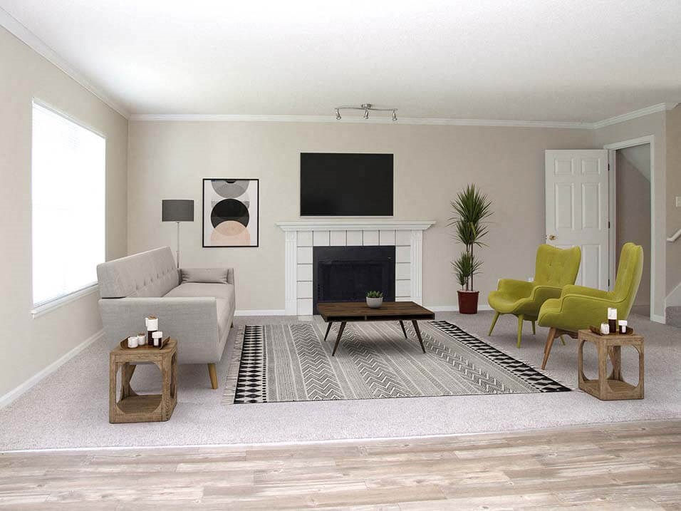 a living room with a couch and chairs and a television