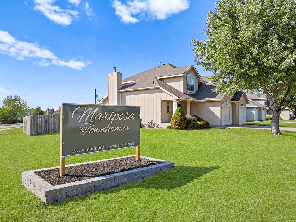 the front yard of a house with a sign that says mariposa gardens