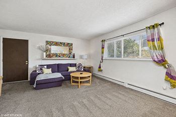a living room with a purple couch and a table