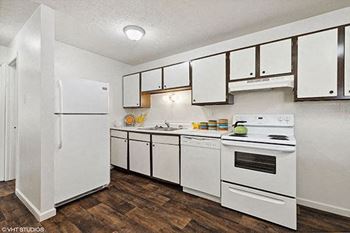a white kitchen with white appliances and white cabinets