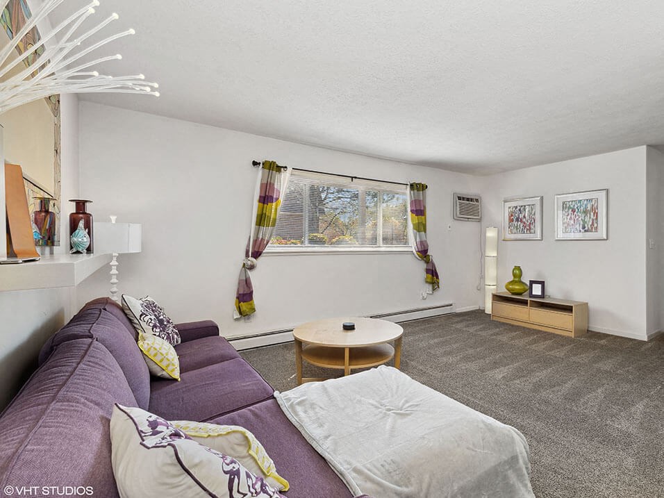 a living room with a purple couch and a table