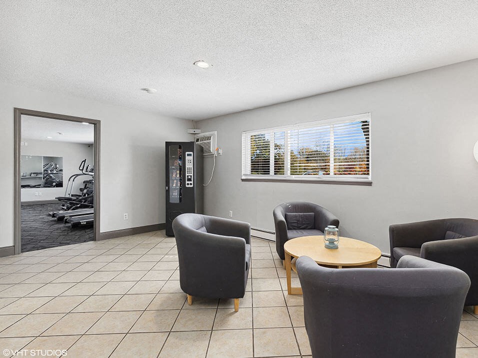 a living room with chairs and a table