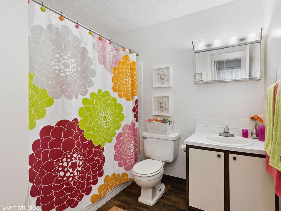 a bathroom with a shower tub and a sink and a toilet