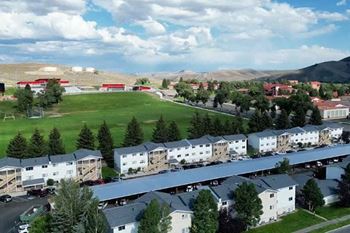 an aerial view of Mountaineer Village Apartments  with field and buildings