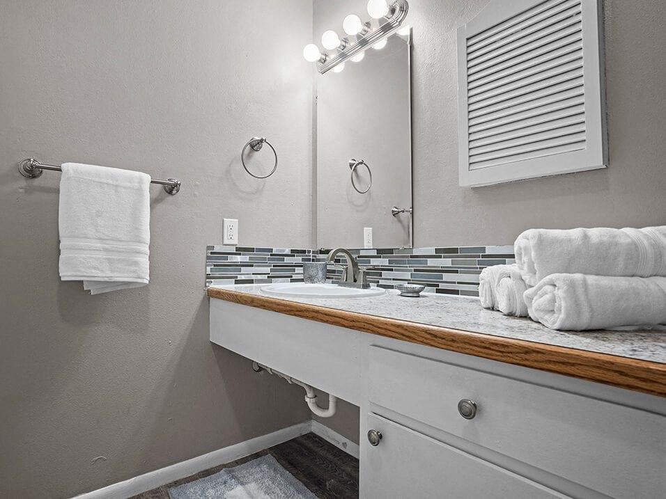 a bathroom with a sink and a mirror and towels