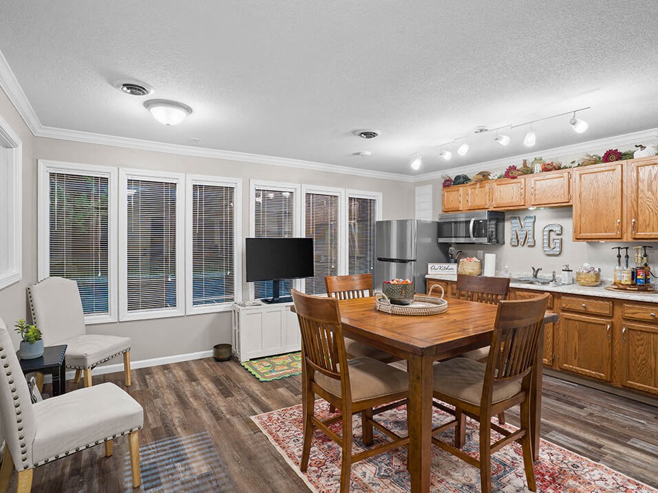 a kitchen and dining room with a table and chairs