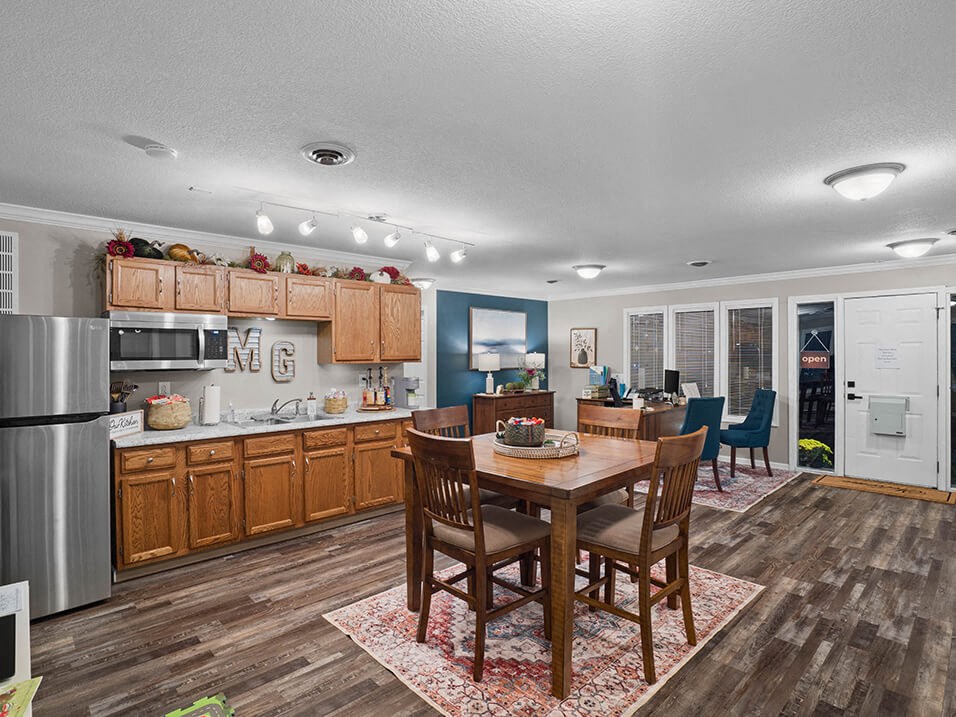a kitchen and dining room with a table and chairs