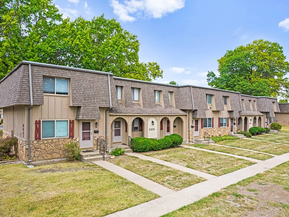a row of houses with trees in the background