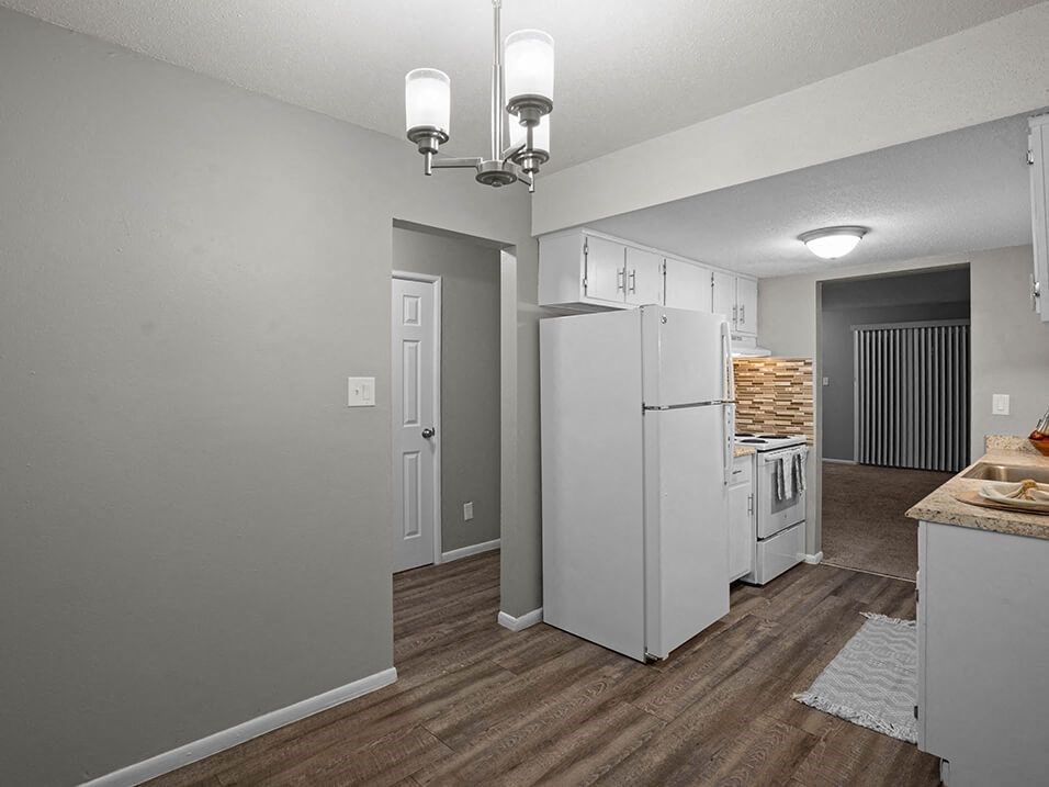 a kitchen with a white refrigerator and a stove