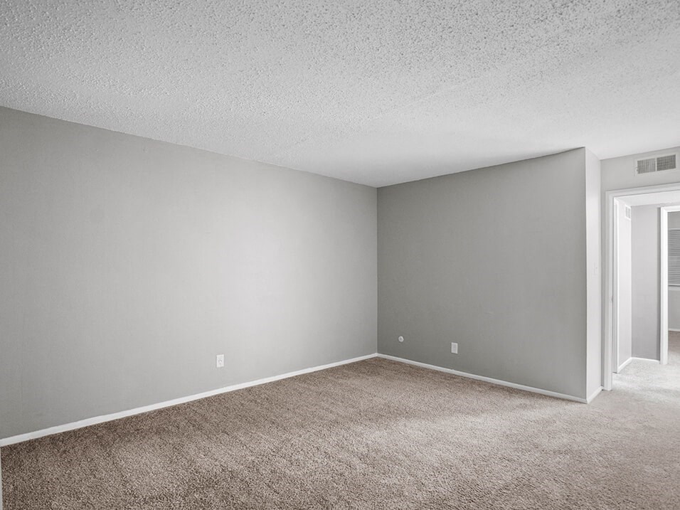 an empty room with a carpeted floor and a door