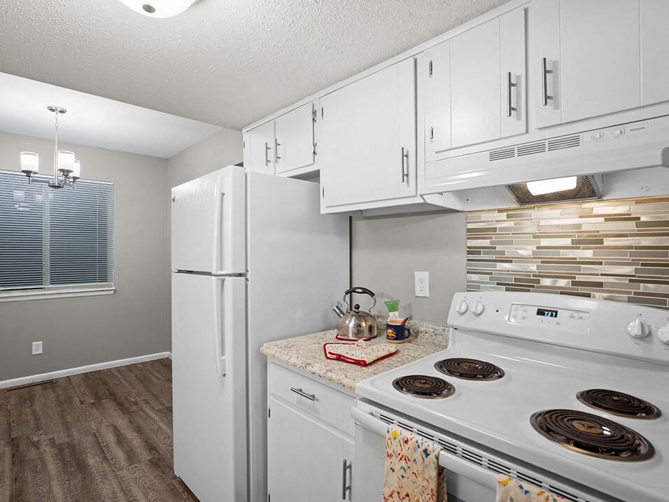 a kitchen with white appliances and white cabinets
