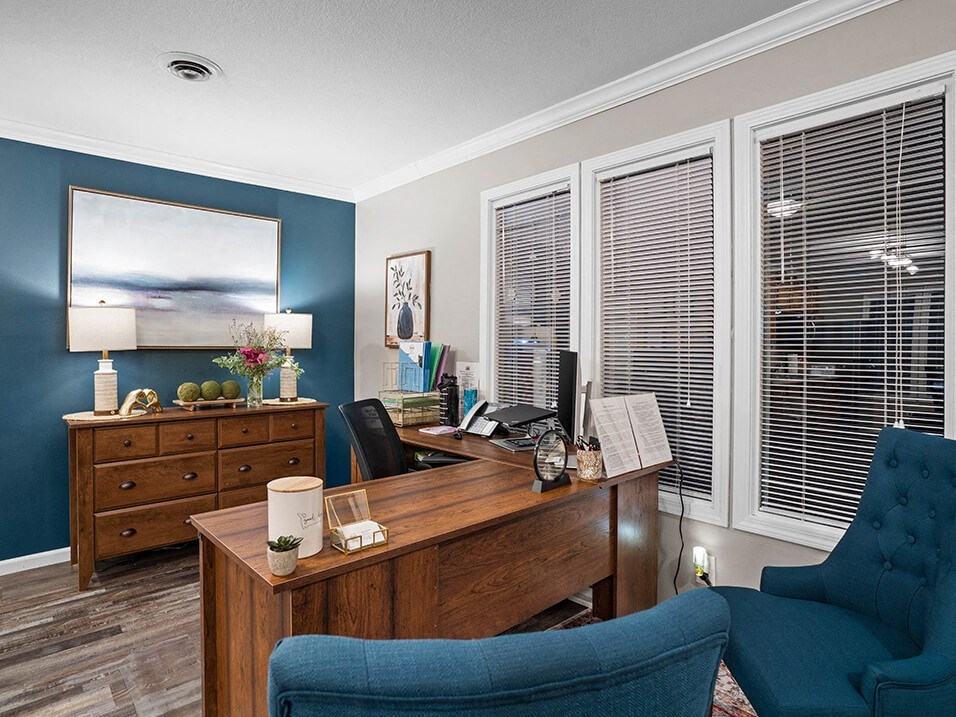 a home office with a desk and a chair