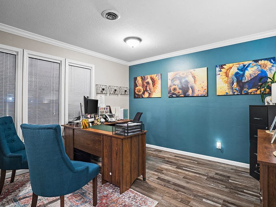 a home office with a desk and chairs