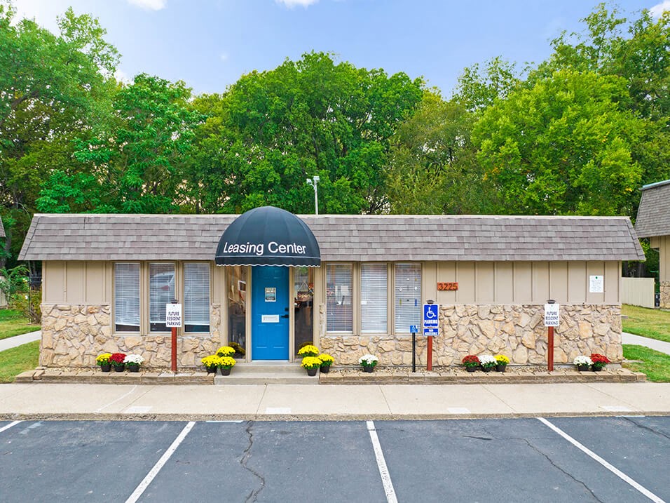 the leasing center is located on the corner of a parking lot