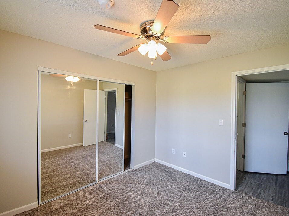 Bedroom with closet and ceiling fan