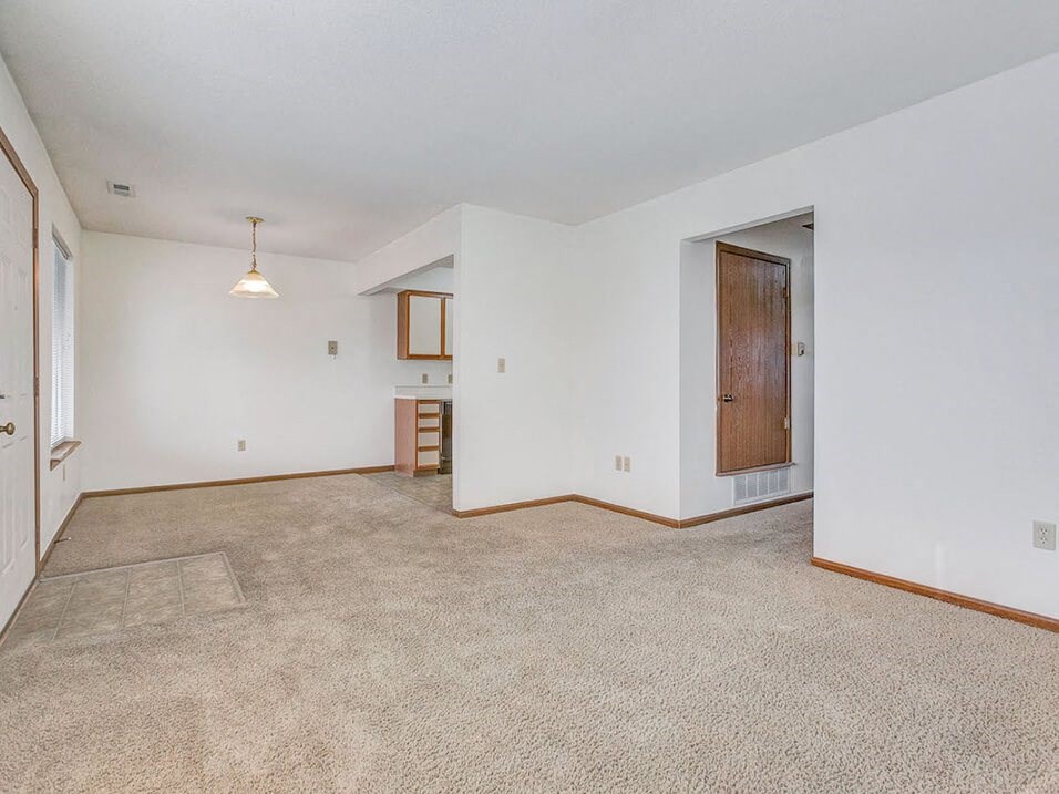 connected and carpeted living and dining area