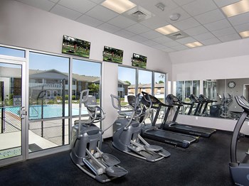fitness center overlooking pool at north park apartments - Photo Gallery 3