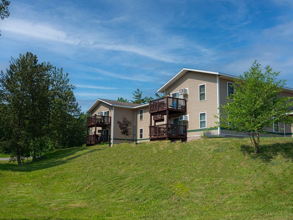 a home on a hill with a blue sky in the background
