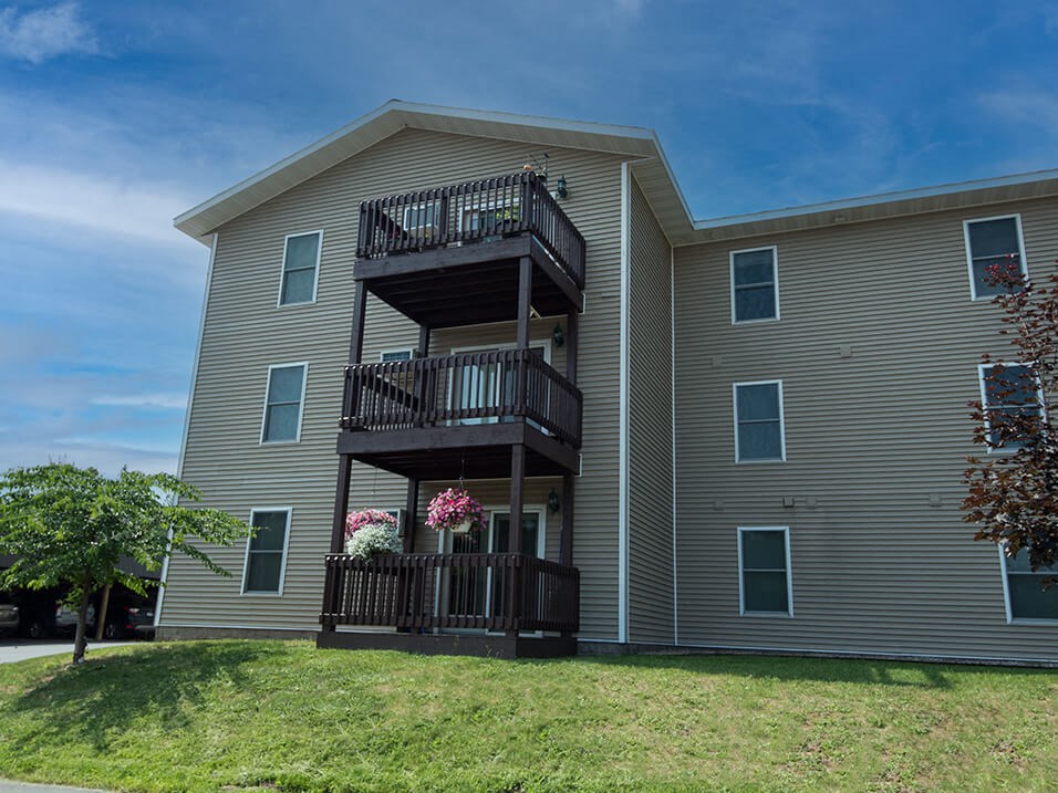 an exterior view of an apartment building with a balcony