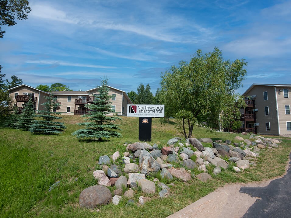 a sign in front of an apartment complex