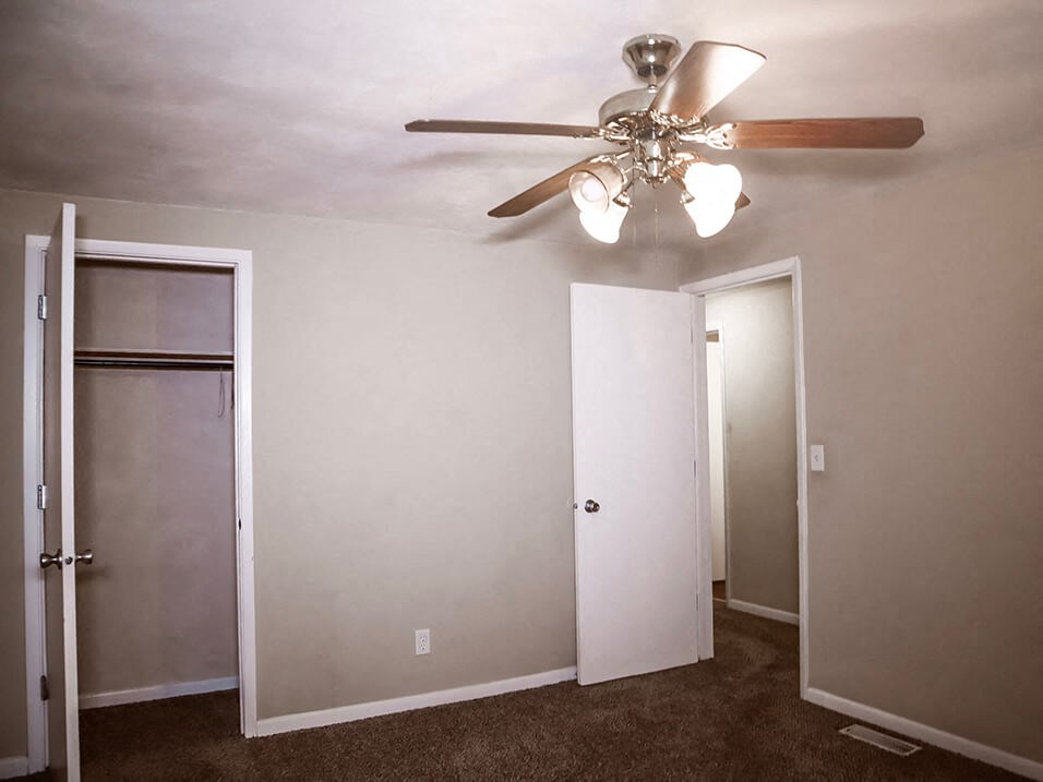 bedroom area with closet and overhead light and fan
