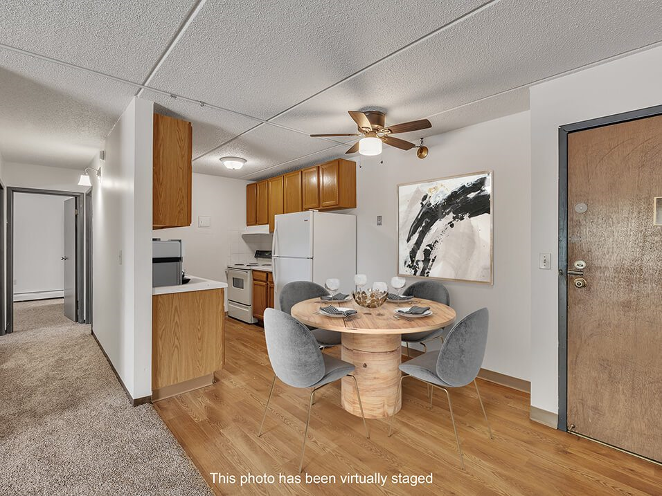 a kitchen and dining room with a table and chairs