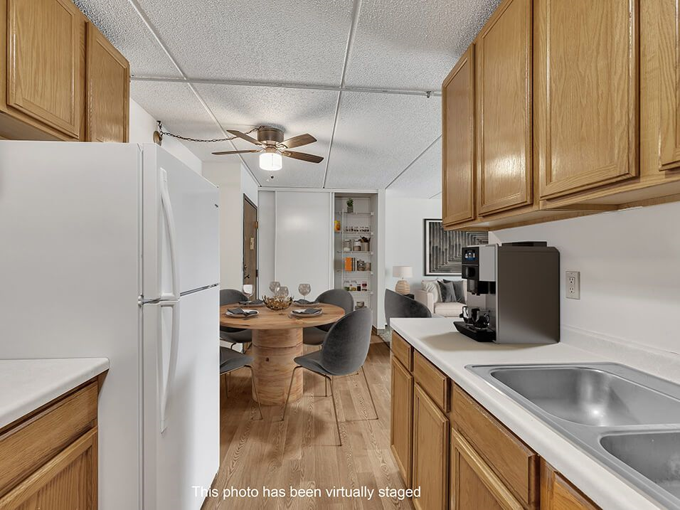 a kitchen with a dining table and a refrigerator