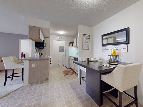a kitchen and dining area with a table and chairs