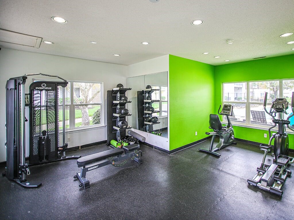 fitness center with weights at apartment community