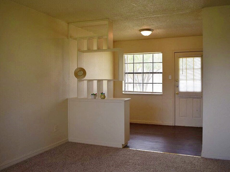 an empty room with a door and a window