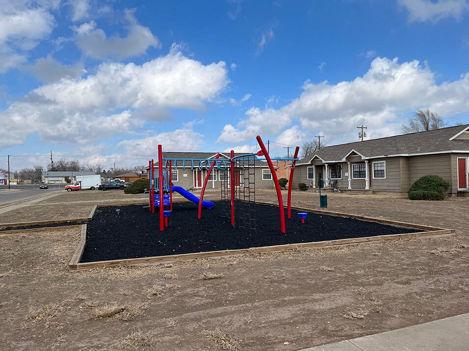 a picture of a playground with a blue sky in the background