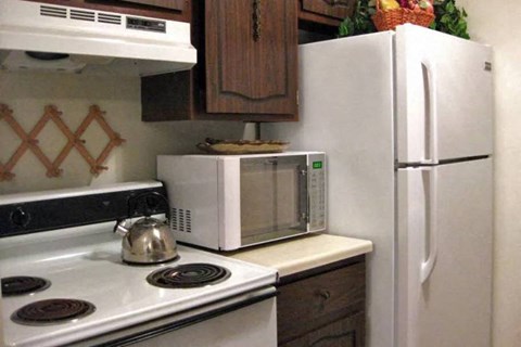 a kitchen with a microwave and a stove and a refrigerator