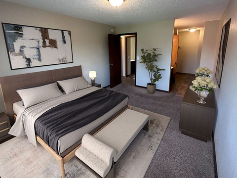 a bedroom with a large bed and a large painting on the wall