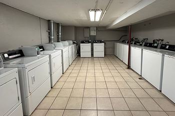 A laundry room with washers and dryers.