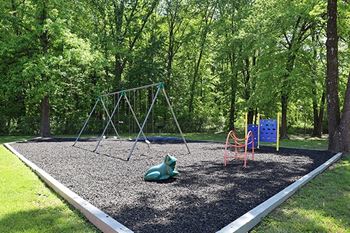 A playground with a swing set and a slide.