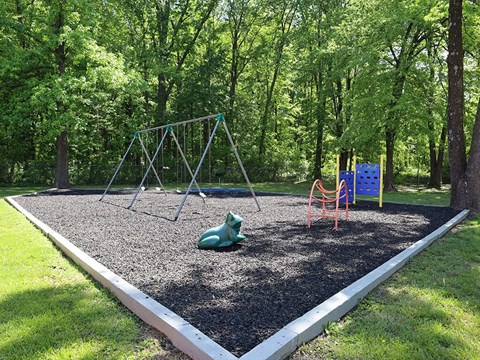 A playground with a swing set and a slide.