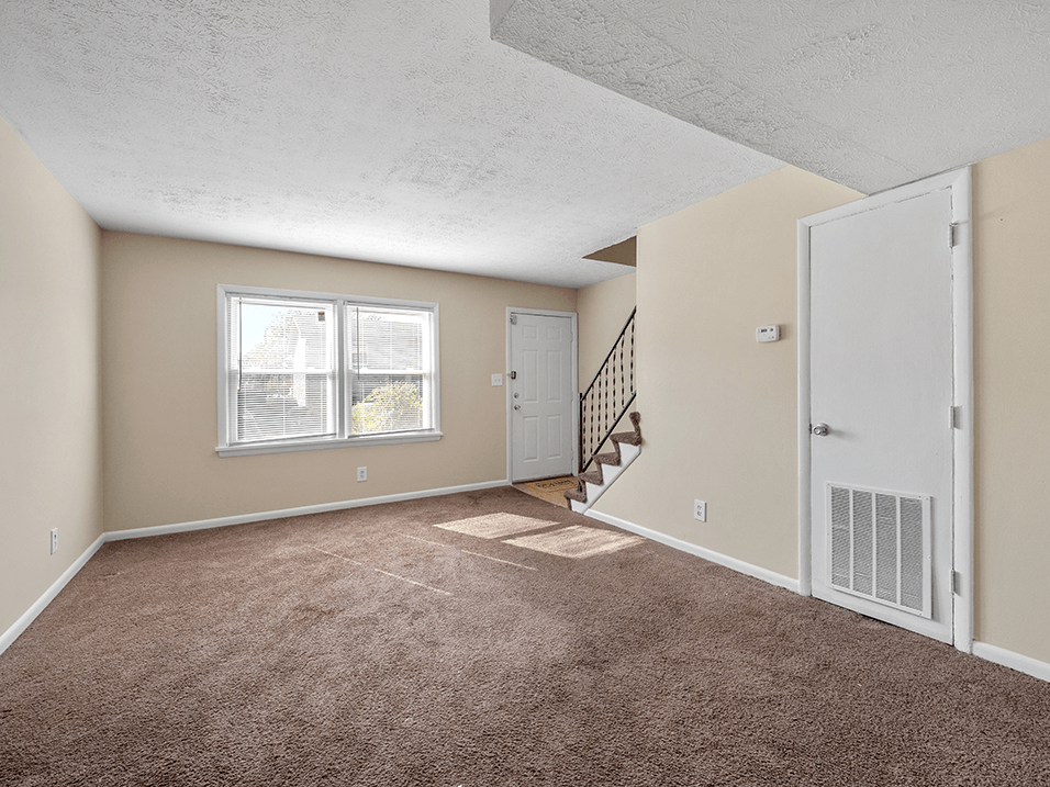 carpeted living room at Preston Oaks Apartments