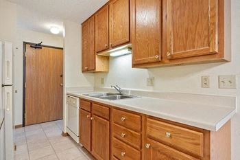 a kitchen with wooden cabinets and a sink