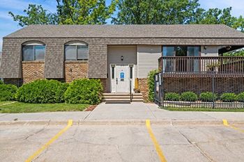 a brick house with a porch and a white door