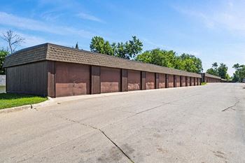a long row of garages on the side of a road